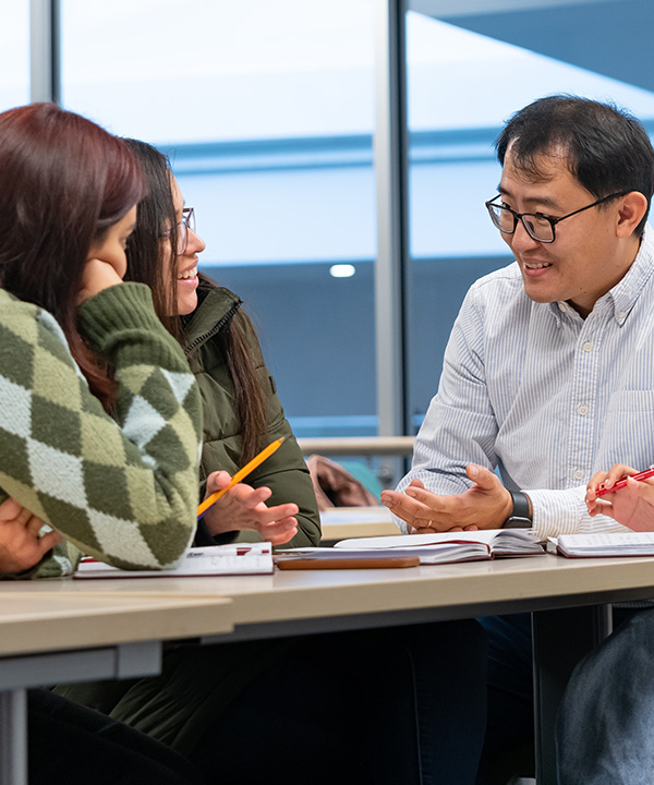 teacher speaking with students