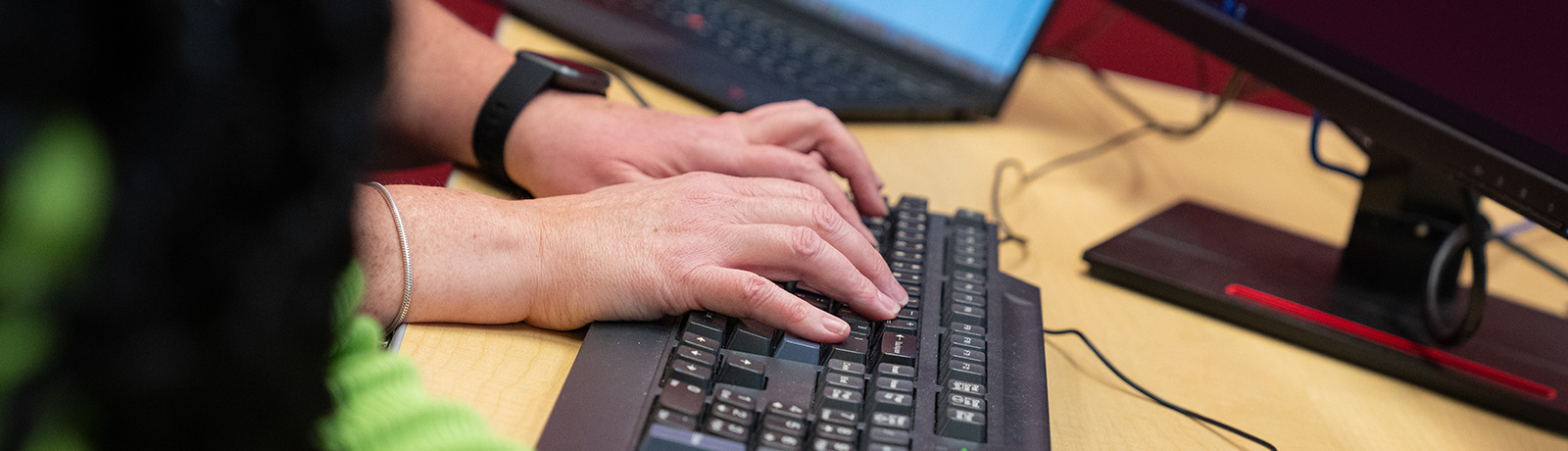 close up of hands on keyboard