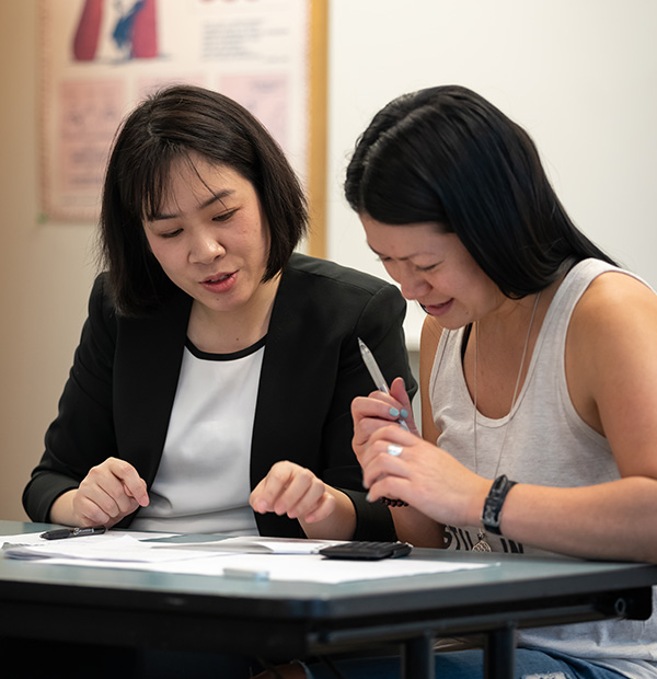 teacher helping student with math and stats work