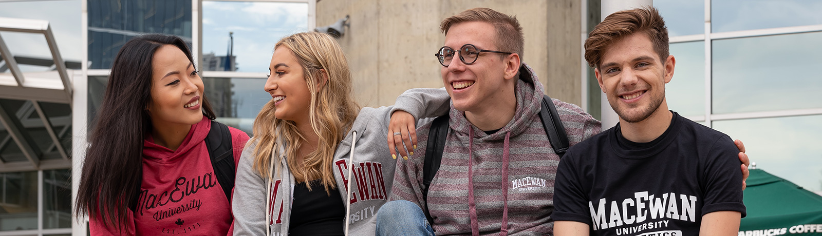 students outside MacEwan smiling