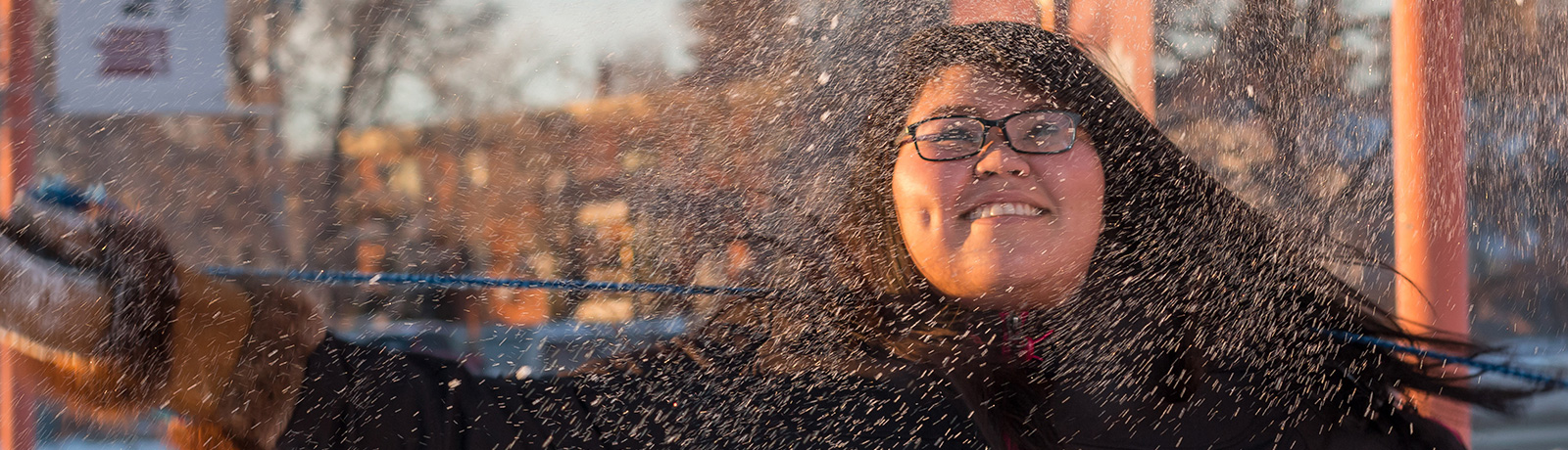 female student throwing snow