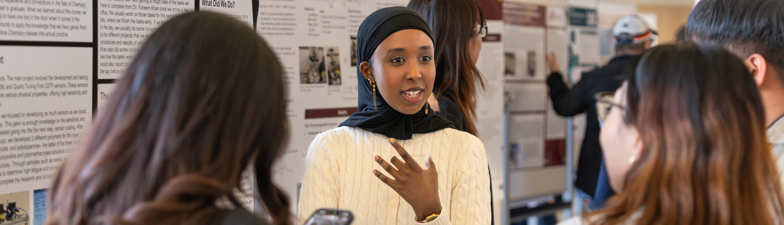 female student speaking to other students