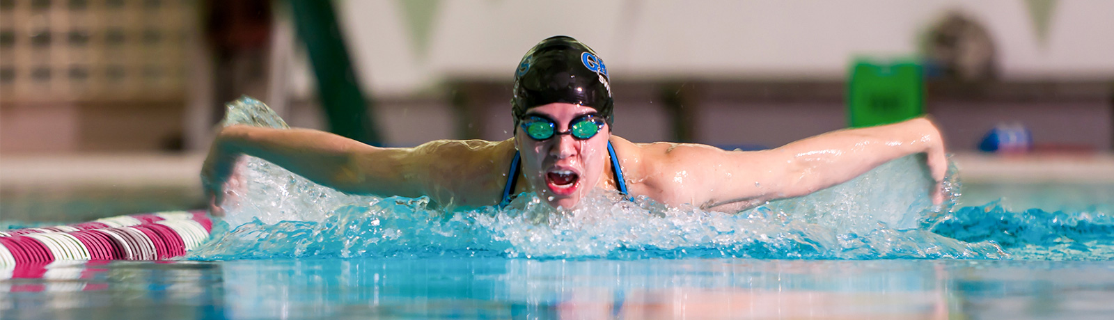 woman swimming in lanes in pool