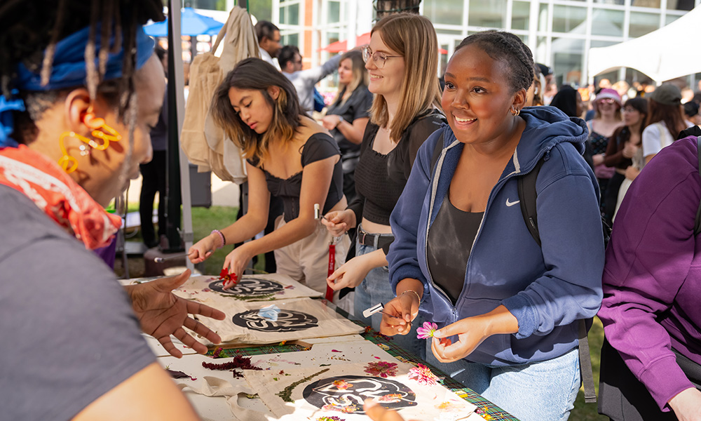 students decorating SAMU bags outdoors