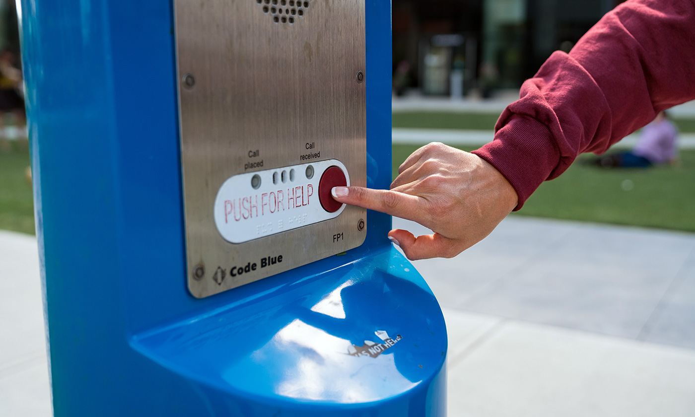 student pushing emergency button